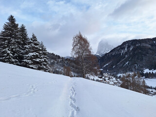 Panorama of the Dolomite Mountains in the snow near the town of Ortisei. Nature of the town of Ortisei in the snow in winter.