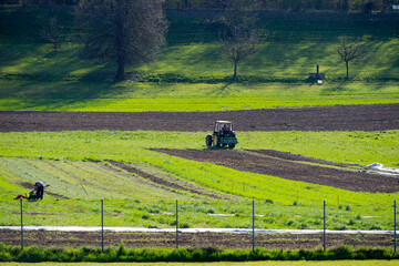Rural landscape of organic farm with freshly ploughed agriculture fields on a sunny spring afternoon. Photo taken April 9th, 2025, Zurich Schwamendingen, Switzerland.