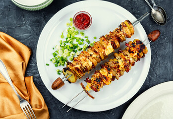 Grilled vegetable skewers with a spicy sauce.
