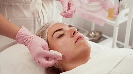 Woman receiving facelift procedure, lying calmly during professional treatment. Patient undergoing gentle facial care, highlighting rejuvenation process. Individual relaxing during non invasive