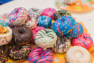Pile of Colorful Donuts with Various Toppings: Sweet Indulgence and Treats