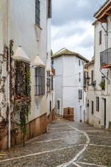 Fototapeta premium A pretty street with traditional Spanish old architecture in Ronda town, Spain, Adalusia