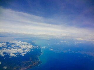 Fototapeta premium Planet earth surface view through airplane flight