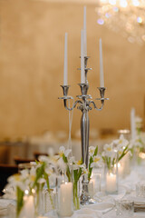 Elegant Table Setting with Candles and Fresh Flowers for Special Occasions