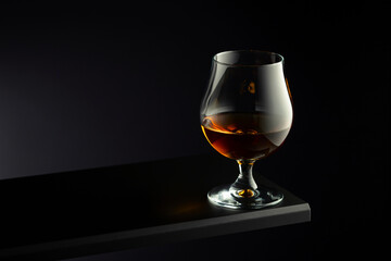 Brandy snifter on a dark background.