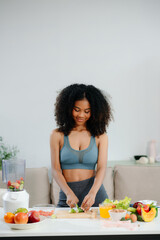 Discover a vibrant wellness scene of a woman blending fresh fruits and vegetables for a healthy lifestyle.