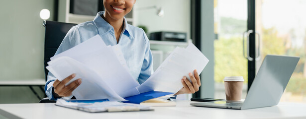 businesswoman working with working notepad, tablet and laptop documents talking on the smartphone,...