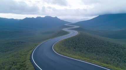 Naklejka premium Winding road through mountain landscape