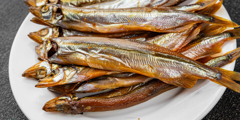 Smoked fish capelin sprat fresh dish gourmet food background on table rustic food top view copy...