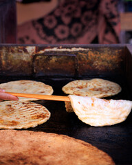 Street food vendor cooking rghaif on a hot plate in Tinghir, Morocco