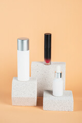 Plastic white tube for cream or lotion. Skin care or sunscreen cosmetic with stylish props on cream background.