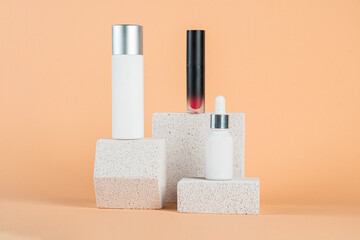 Plastic white tube for cream or lotion. Skin care or sunscreen cosmetic with stylish props on cream background.