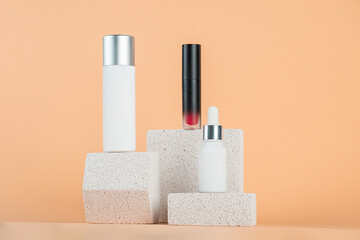 Plastic white tube for cream or lotion. Skin care or sunscreen cosmetic with stylish props on cream background.