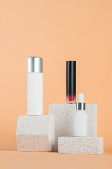 Plastic white tube for cream or lotion. Skin care or sunscreen cosmetic with stylish props on cream background.