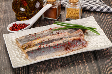 Salted marinated herring fillet with spices