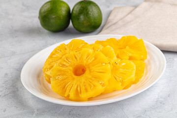 Sweet canned pineapple slices in syrope