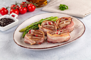 Tasty grilled pork medallion with bacon