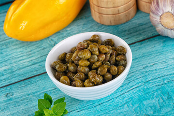 Pickled canned capers in the bowl