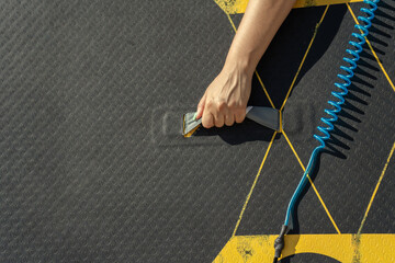 Woman carrying paddle board walking on the beach