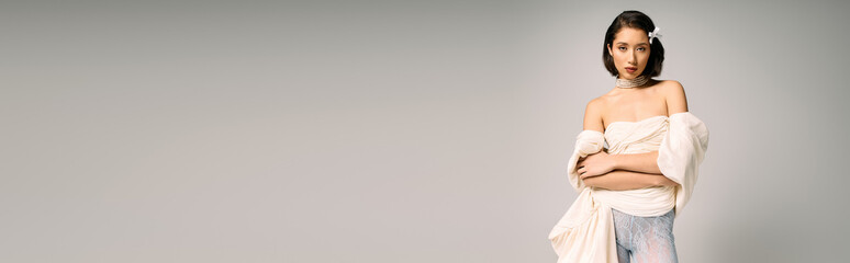 Radiating elegance, a young bride stands poised in a stunning wedding gown, captivated by love