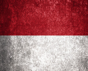 Monaco State Flag. Dirty Monaco flag on metal surface.