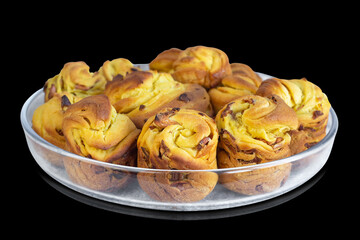 Easter cakes on a glass dish, isolated on a black background. Selective focus