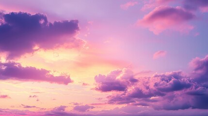 Fototapeta premium A dreamy, pastel sunset sky filled with fluffy clouds.