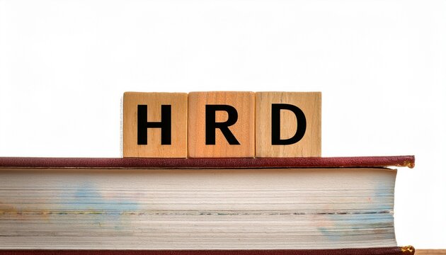 A stack of books with wooden blocks displaying the letters "HRD," suggesting a focus on human resources development or related topics.