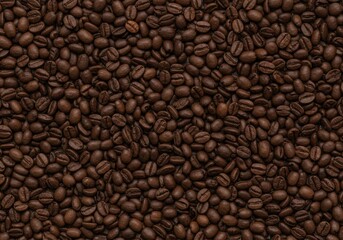 Rich coffee beans scattered on a dark surface awaiting preparation for brewing