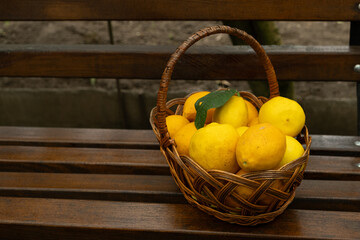 Basket full of fresh ripe lemons close-up.