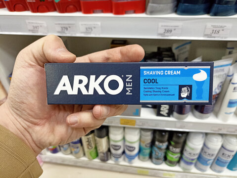 Arko men shaving cream cool variant held in shopping aisle