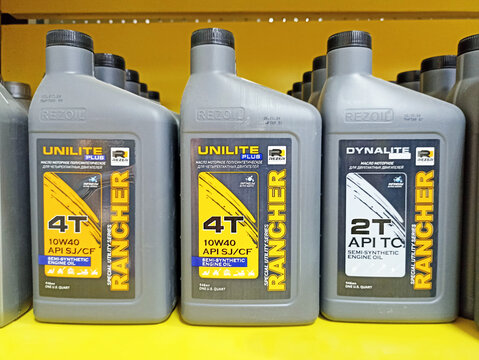 Motor oil bottles display on shelf with unilite and dynalite labels
