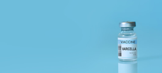 Close-up of a medical vial labeled Varicella vaccine placed on a blue background, symbolizing healthcare, scientific research, immunization awareness, and modern medicine. Banner with copy space