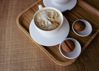 Two white coffee cups with sweet pastry in wooden tray. Breakfast flat lay. Morning aroma coffee and dessert. Americano with milk and biscuits. Elegant lifestyle. Hot aroma cups and cookies.