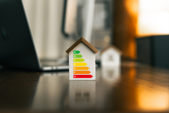 Energy-saving house concept, reduce energy consumption in the house, toy house on the desk in the house