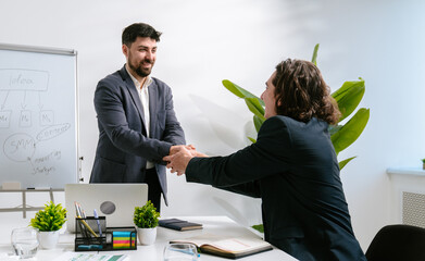 Business Meeting with Handshake and Strategy Discussion