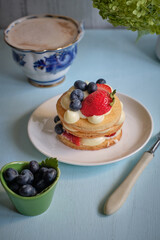 Mille-feuille cake of homemade puff pastry with strawberries and blueberries
