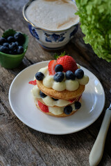 Mille-feuille cake of homemade puff pastry with strawberries and blueberries