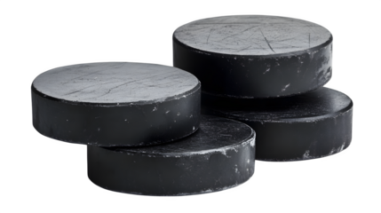 Stack of black hockey pucks with subtle texture,