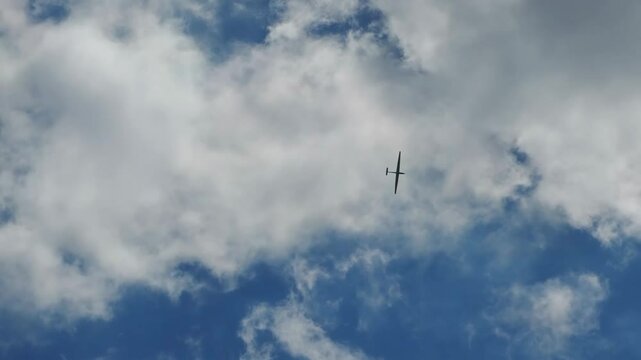 a glider makes a circle in the blue sky