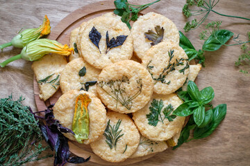cheese cookies with different types of aromatic herbs, edible flowers