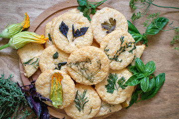 cheese cookies with different types of aromatic herbs, edible flowers