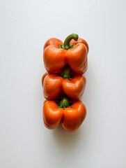 Stack of three orange bell peppers