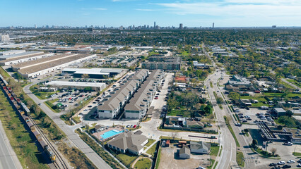 Obraz premium Apartment building complex with swimming pool in industrial corridor of Houston submarket along Hempstead railroad, US-290, Highway 6, Interstate 10, complex logistics, warehousing regional hubs