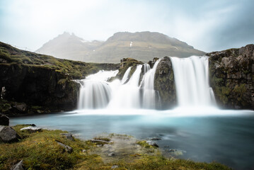 View to the Kirkjufell waterfall at summer. Kirkjufellsfoss waterfall, Iceland, Europe.