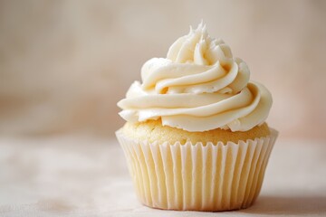 A single cupcake topped with creamy white frosting stands tall