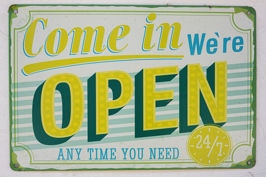 Vintage open signboard showing availability with 24/7 service for customer convenience