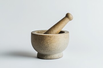 A stone mortar and pestle resting on a white surface