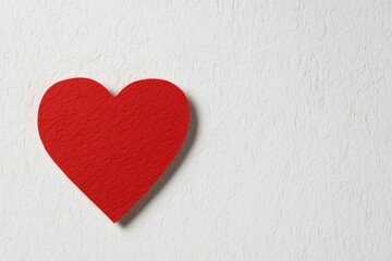 Obraz premium Red heart shape against textured white background conveys love a