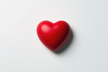 Obraz premium Bright red heart resting on smooth surface, symbolizing love and